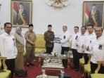 GM PLN Unit Wilayah Induk Sumatera Selatan, Jambi dan Bengkulu (W2SJB), Amris Adnan menyerahkan secara simbolis bantuan tanggung jawab sosial & lingkungan (TJSL) Desa Sungai Lisai/ Alat Penyalur Daya Listrik (APDAL) Stasiun Pengisian Energi Listrik (SPEL) kepada Gubernur Bengkulu Rohidin Mersyah, disaksikan Asisten II Pemprov Bengkulu, Fachriza Razie (ketiga dari kiri), bertempat di Balai Raya Semarak Bengkulu.(Foto/Ist)