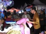 Presiden Joko Widodo disaksikan Gubernur Bengkulu, Rohidin Mersyah membeli gulali jualan pedagang pasar malam di arena Festival Tabot Bengkulu 2023, di lapangan Merdeka, Kota Bengkulu, Rabu malam.(Foto/Ist)