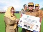 Wali Kota Bengkulu, Dedy Wahyudi menyerahkan hadiah Umroh kepada ASN Pemkot Bengkulu yang berprestasi senilai Rp 40 juta. Hadiah ini diberikan sebagai apresiasi atas kinerja dan prestasi serta didiikasi sebagai ASN dalam melayani masyarakat.(Foto/Ist)