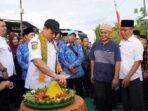 Wali Kota Bengkulu, Dedy Wahyudi memotong nasi tempung saat menghadiri syukuran warga Kopmlek Perum Griya Andikan di Kelurahan Sumur Dewa, Kecamatan Selebar atas selesai pembangunan jalan aspal hotmix di komplek tersebut.(Foto/Ist)
